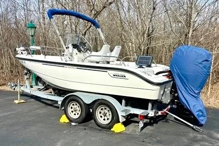 Slide: The Image of 2005 Boston Whaler DAUNTLESS 180 boat on trailer, parked outdoors with cover. - 7
