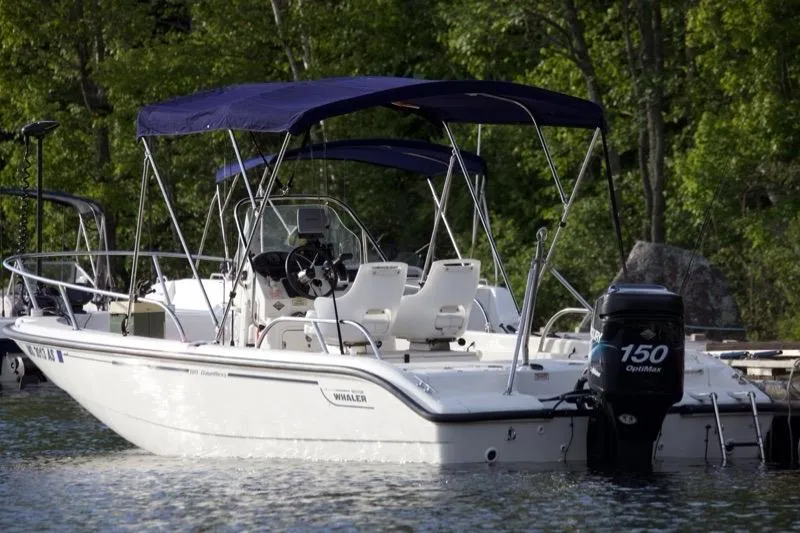 Slide: The Image of 2005 Boston Whaler DAUNTLESS 180 boat with canopy on a calm lake. - 8