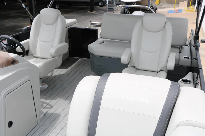 Slide: The Image of 2026 Sylvan Mirage Cruise 8520 CLZ DH interior with plush seating and modern design. - 19