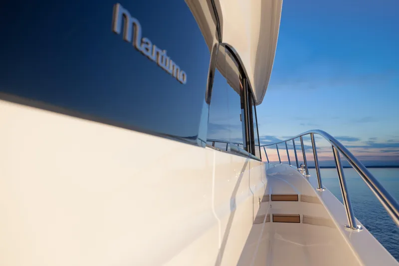 Slide: The Image of 2026 Maritimo M50 yacht side view at sunset on calm waters. - 23