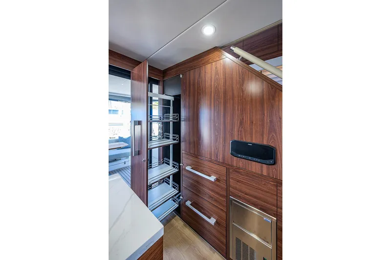 Slide: The Image of Luxurious Maritimo M50 yacht interior with sleek wooden cabinetry and modern storage solutions, 2026 model. - 27