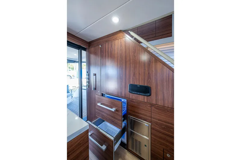 Slide: The Image of Luxurious interior of 2026 Maritimo M50 yacht with modern wood cabinetry and appliances. - 28