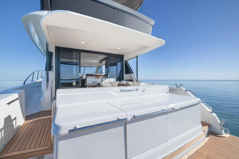 Slide: The Image of Luxury Maritimo M50 yacht, 2026 model, with sleek design and spacious deck on calm sea. - 3