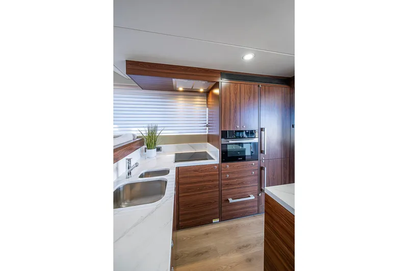 Slide: The Image of Modern kitchen interior of 2026 Maritimo M50 yacht with wood cabinetry and stainless steel appliances. - 30