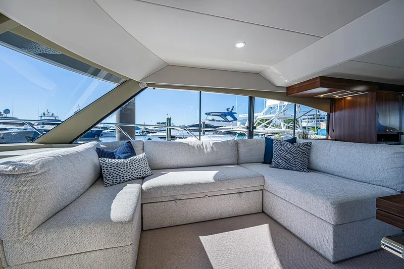 Slide: The Image of Luxurious interior of 2026 Maritimo M50 yacht with plush seating and marina view. - 36