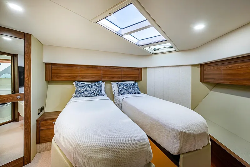 Slide: The Image of Luxurious twin cabin interior of 2026 Maritimo M50 yacht with skylight and wooden accents. - 47