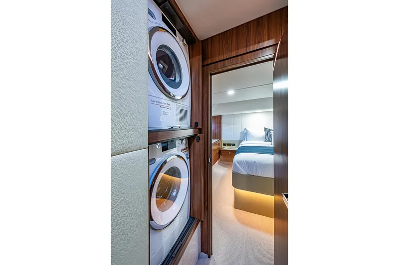 Slide: The Image of Laundry area and bedroom inside a 2026 Maritimo M50 yacht. - 52