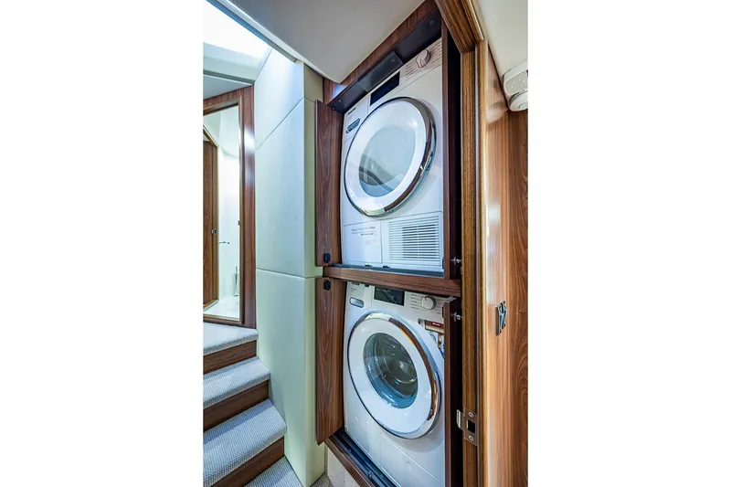Slide: The Image of Laundry area with stacked washer and dryer in 2026 Maritimo M50 yacht. - 53