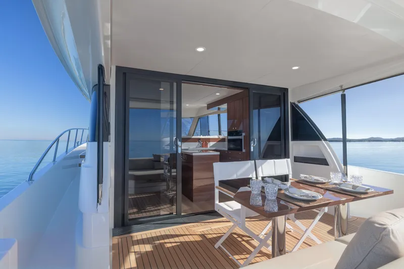 Slide: The Image of Luxurious 2026 Maritimo M50 yacht with elegant dining area and stunning ocean view. - 6