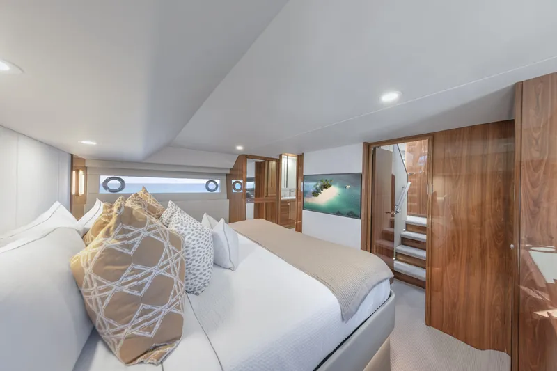 Slide: The Image of Luxurious interior of 2026 Maritimo M50 yacht with elegant wood finishes and plush bedding. - 7
