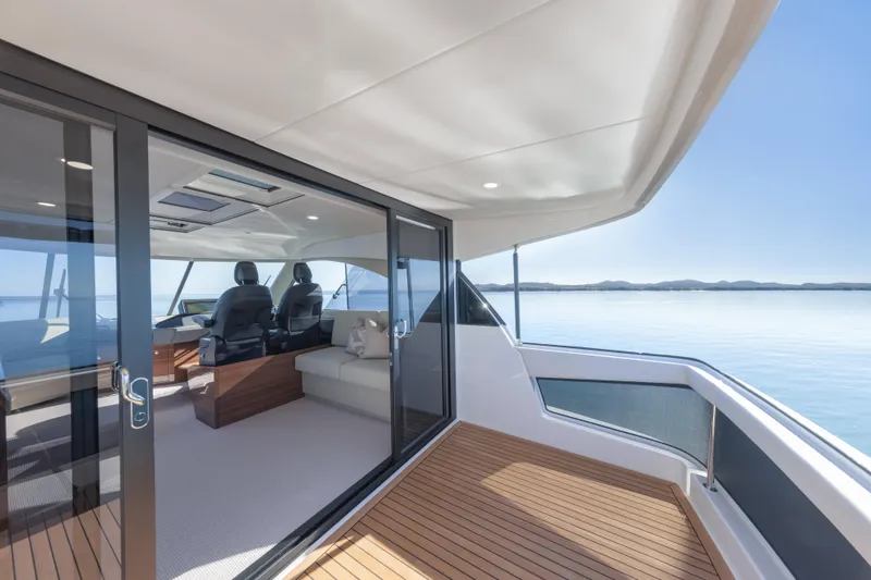 Slide: The Image of Luxurious interior view of 2026 Maritimo M50 yacht with sliding glass doors and marina backdrop. - 76