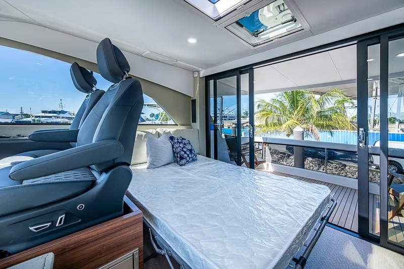 Slide: The Image of Interior of 2026 Maritimo M50 yacht with seating and convertible bed. - 77