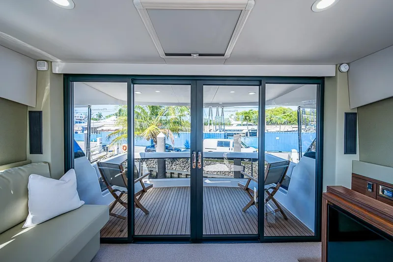 Slide: The Image of Luxurious interior of 2026 Maritimo M50 yacht with sliding glass doors and outdoor seating. - 79
