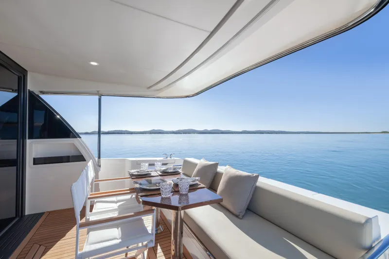 Slide: The Image of Luxury Maritimo M50 yacht deck and interior, 2026 model, featuring elegant seating and modern design. - 82