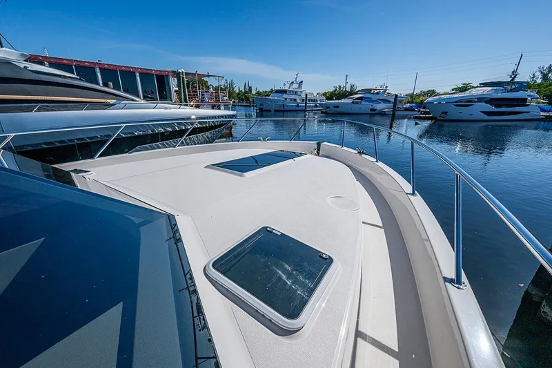 Slide: The Image of 2026 Maritimo M50 yacht docked in a marina under clear blue skies. - 91