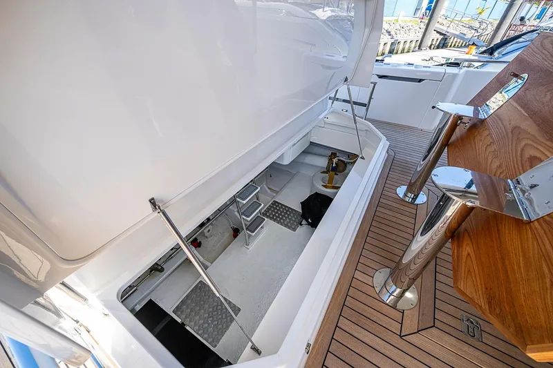Slide: The Image of 2026 Maritimo M50 yacht storage compartment with open hatch and teak deck. - 92