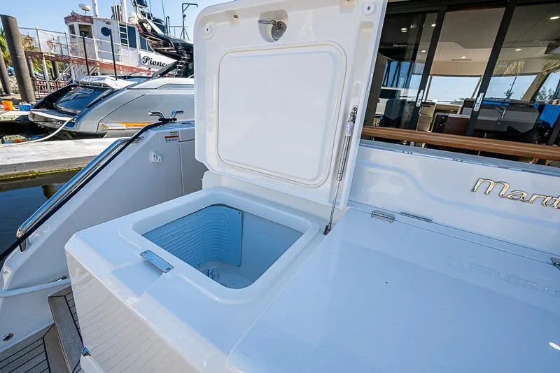 Slide: The Image of Open storage compartment on 2026 Maritimo M50 yacht, docked at marina. - 96