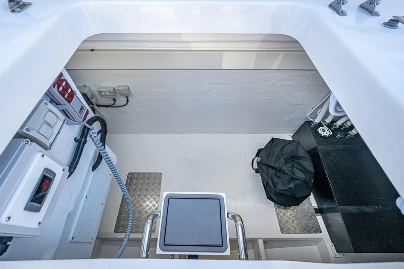 Slide: The Image of Engine compartment of 2026 Maritimo M50 yacht, featuring control panels and wiring. - 99