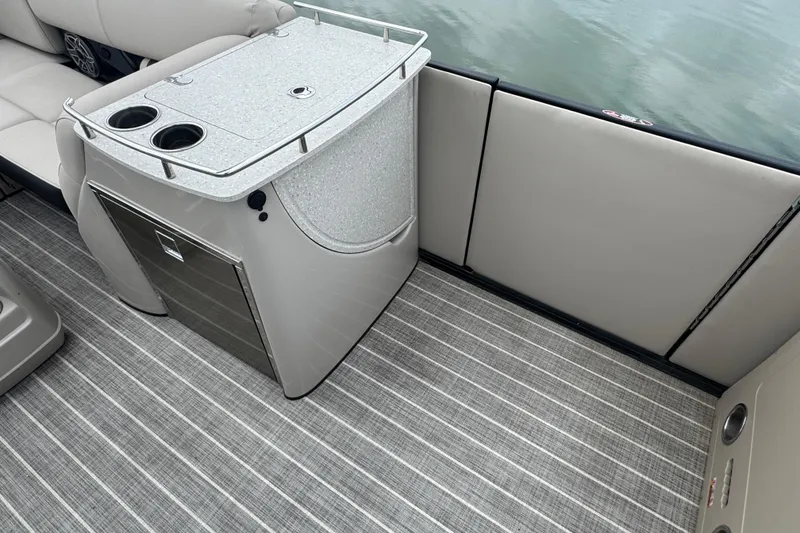 Slide: The Image of Interior of 2023 Harris Grand Mariner 250 boat with seating and built-in cooler. - 12