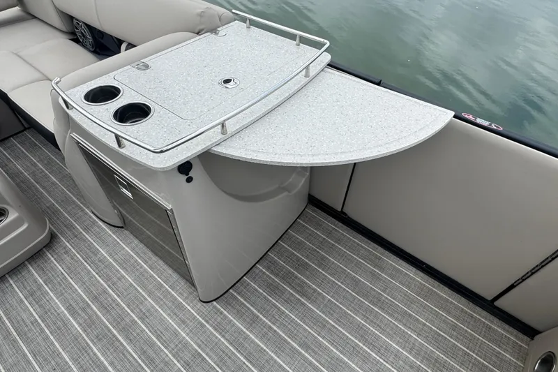 Slide: The Image of 2023 Harris Grand Mariner 250 boat interior with a sleek bar counter and cup holders. - 13