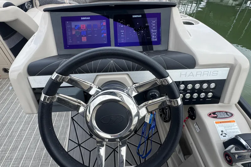 Slide: The Image of 2023 Harris Grand Mariner 250 dashboard with dual Simrad displays and steering wheel. - 17
