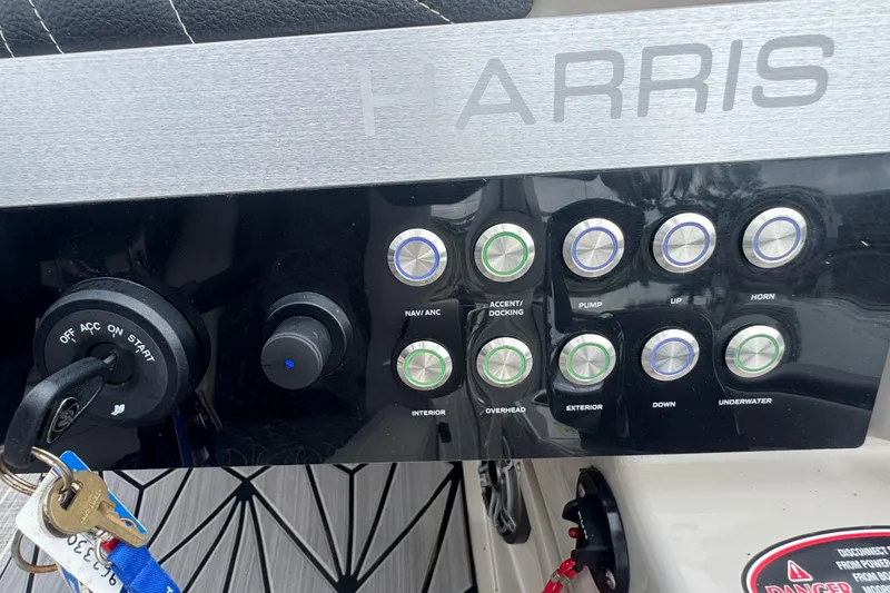 Slide: The Image of Control panel of 2023 Harris Grand Mariner 250 boat with labeled buttons and ignition keys. - 19