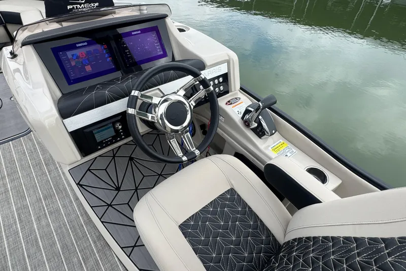 Slide: The Image of 2023 Harris Grand Mariner 250 helm with modern controls and dual Simrad displays. - 21