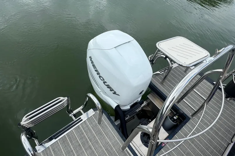 Slide: The Image of 2023 Harris Grand Mariner 250 boat with Mercury outboard motor on water. - 26