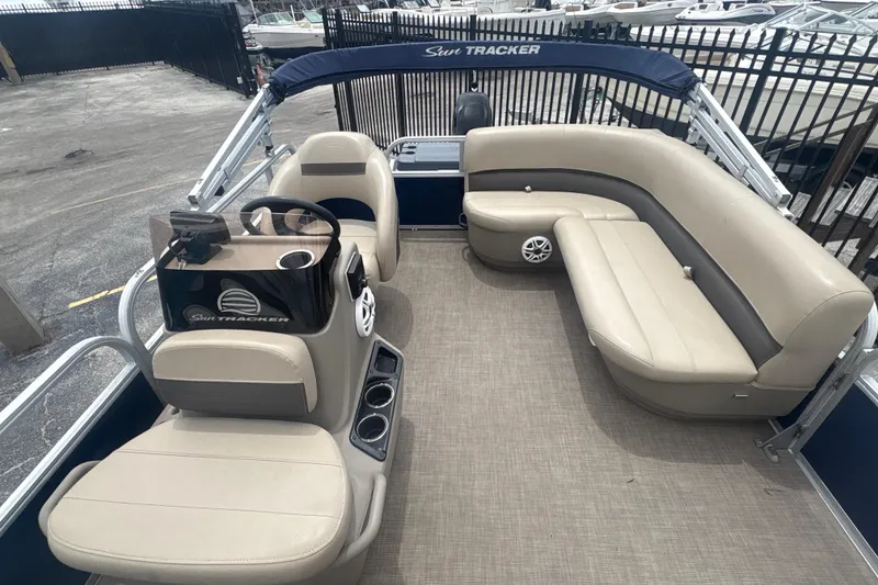 Slide: The Image of 2022 Sun Tracker Bass Buggy 16 XL Select pontoon boat with beige seating and steering console. - 5