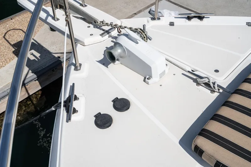 Slide: The Image of Bow deck of 1992 Bayliner 4388 yacht with anchor chain and striped cushion. - 10