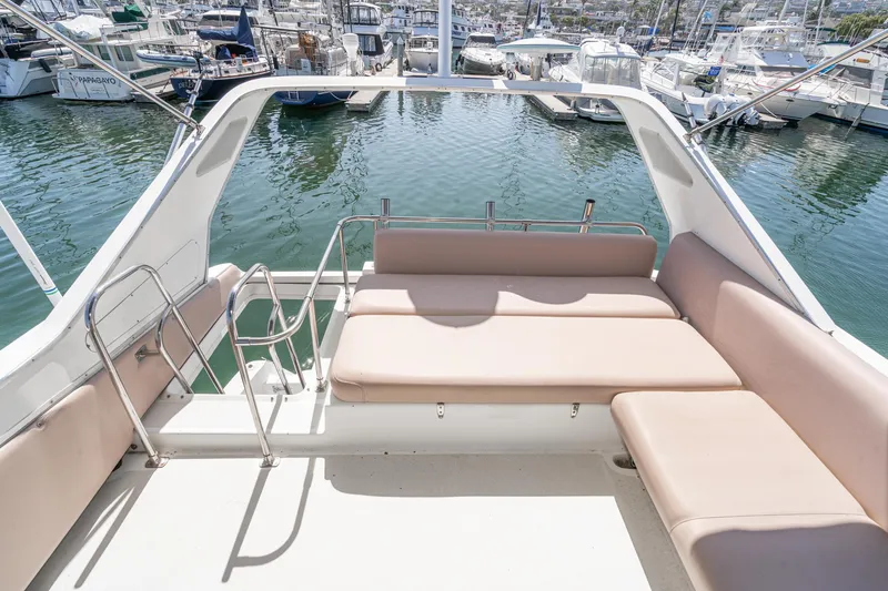 Slide: The Image of 1992 Bayliner 4388 boat with spacious seating area in a marina setting. - 17