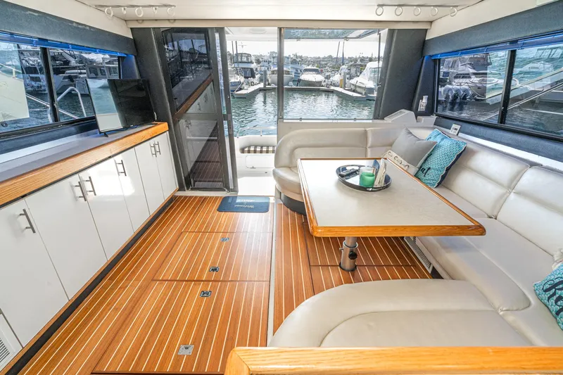 Slide: The Image of Luxurious interior of 1992 Bayliner 4388 yacht with elegant seating and wooden flooring. - 23