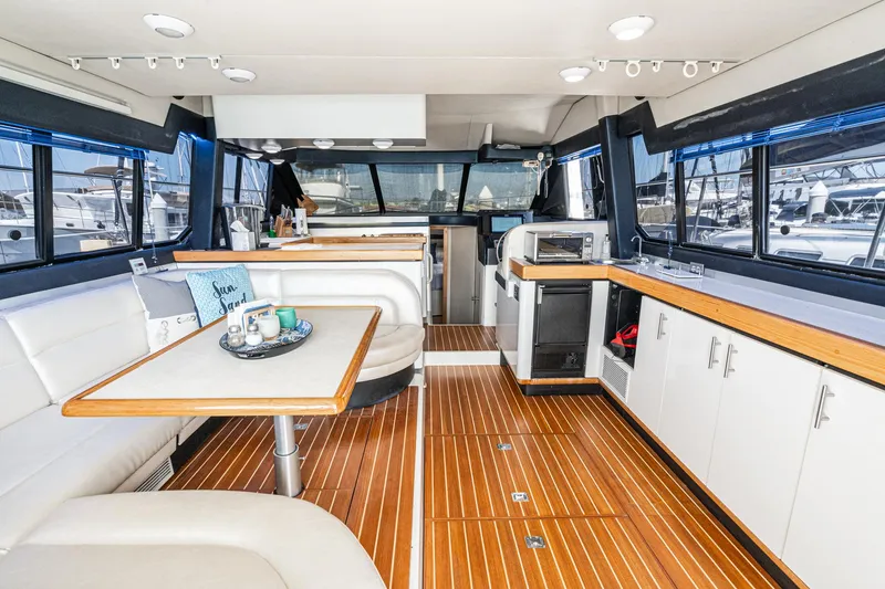Slide: The Image of Interior of 1992 Bayliner 4388 yacht with modern seating and wooden flooring. - 24