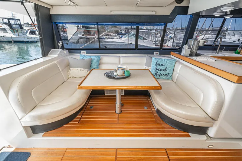Slide: The Image of Luxurious interior of 1992 Bayliner 4388 yacht with cozy seating and elegant table. - 25