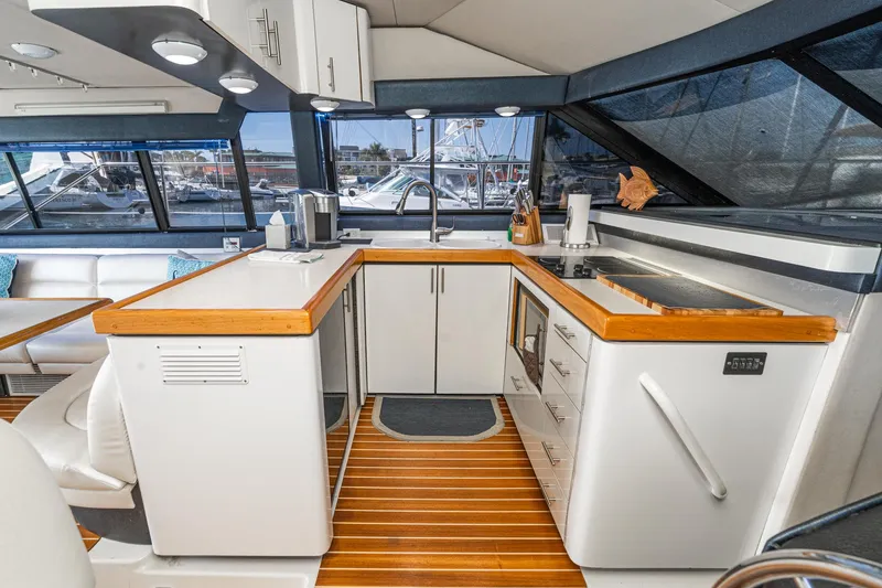 Slide: The Image of Interior of 1992 Bayliner 4388 yacht kitchen with wood accents and modern appliances. - 33