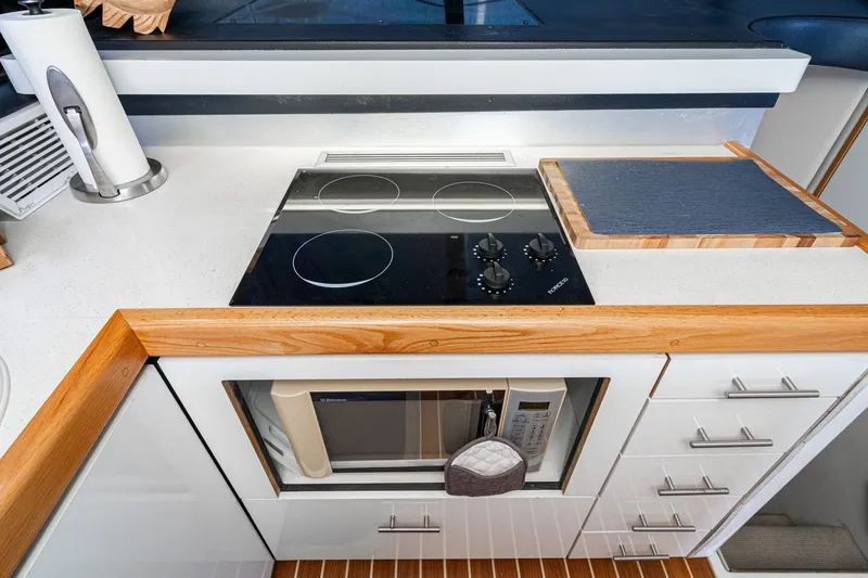 Slide: The Image of Modern kitchen in a 1992 Bayliner 4388 yacht with stove and microwave. - 36