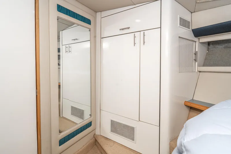 Slide: The Image of Interior of 1992 Bayliner 4388 yacht with white cabinetry and mirror. - 42