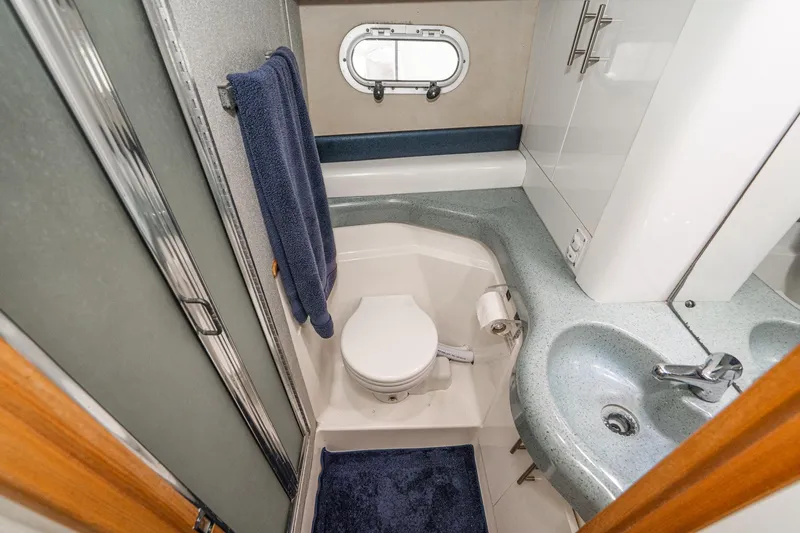 Slide: The Image of Bathroom interior of 1992 Bayliner 4388 yacht with sink, toilet, and shower. - 48