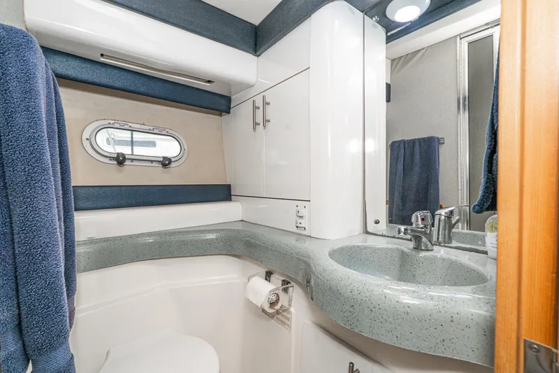 Slide: The Image of Bathroom interior of 1992 Bayliner 4388 yacht with modern sink and porthole window. - 49