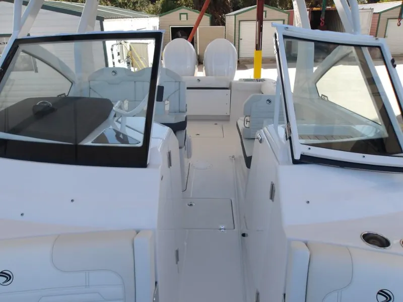 Slide: The Image of 2025 Edgewater 262 CX boat interior with dual consoles and seating. - 25