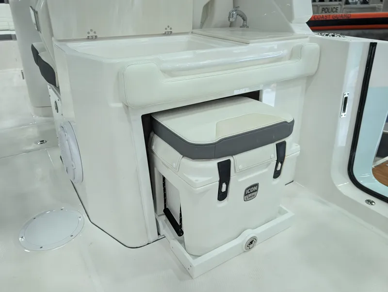 Slide: The Image of 2025 Edgewater 262 CX boat interior with integrated cooler and sink station. - 39