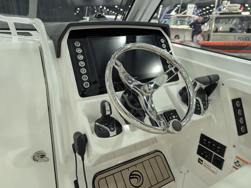 Slide: The Image of 2025 Edgewater 262 CX boat dashboard with steering wheel and control panel. - 40