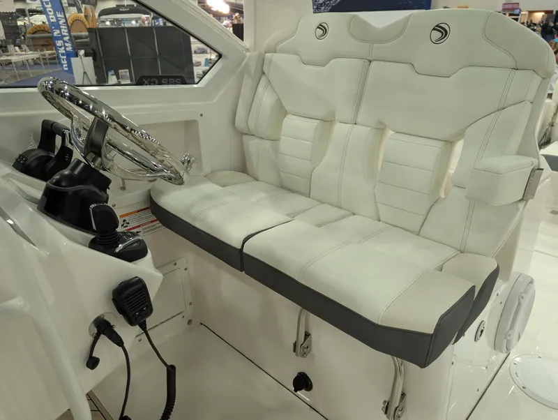 Slide: The Image of 2025 Edgewater 262 CX boat interior with white leather seating and steering wheel. - 41