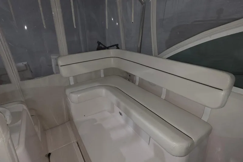 Slide: The Image of 2005 Tiara 290 Coronet boat interior with white cushioned seating. - 10