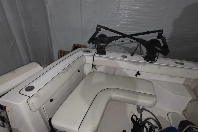 Slide: The Image of 2005 Tiara 290 Coronet boat interior with fishing rod holders and seating. - 11