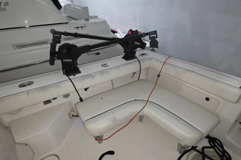 Slide: The Image of 2005 Tiara 290 Coronet boat interior with fishing rod holders and seating area. - 12