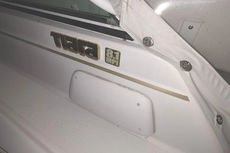 Slide: The Image of 2005 Tiara 290 Coronet boat interior with logo and white upholstery details. - 13