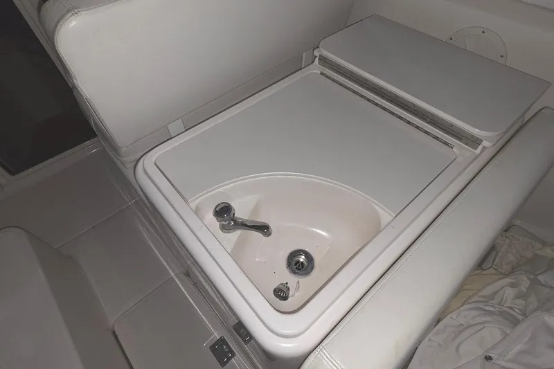 Slide: The Image of 2005 Tiara 290 Coronet boat interior sink with closed lid. - 15