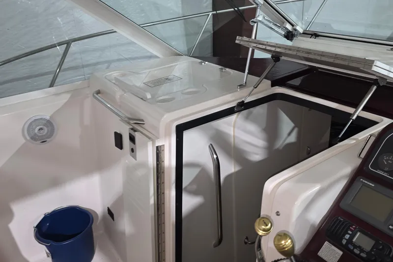 Slide: The Image of Interior view of a 2005 Tiara 290 Coronet boat, featuring helm and cabin entrance. - 16