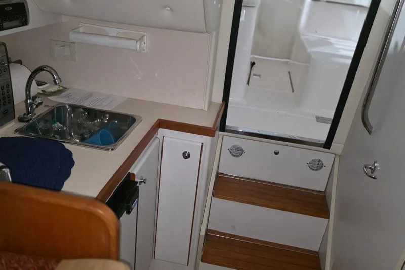 Slide: The Image of 2005 Tiara 290 Coronet interior with kitchenette and wooden steps. - 17
